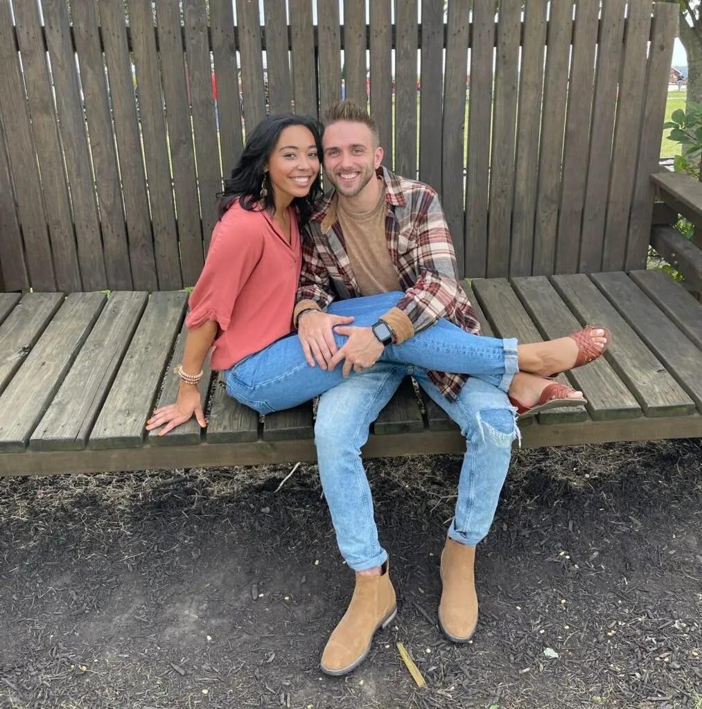 Sierra and Cody sitting together on a big wooden bench.